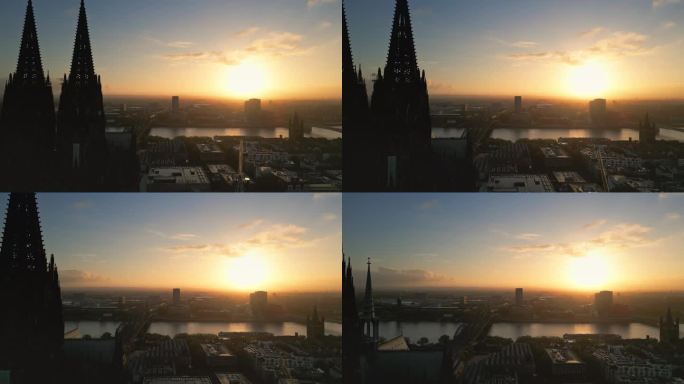 鸟瞰图:日出时分飞过科隆大教堂和霍亨索伦桥的实时画面，德国科隆市中心，