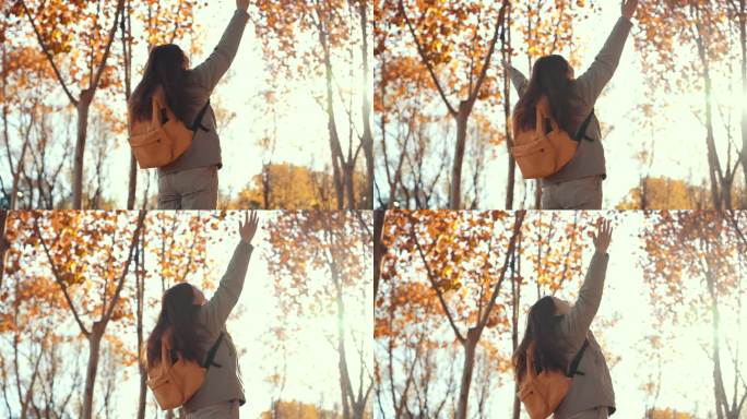 秋天的树林里，女人举起双手