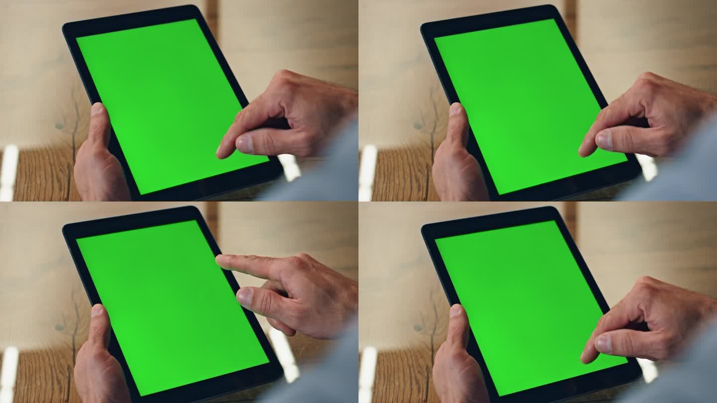 老板手指滑动绿屏平板电脑办公室。导演手滚屏电脑