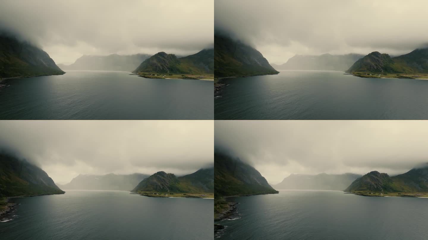 史诗般的全景广阔的水面之间的常绿北欧峡湾山峰，隐藏在雾。无人机的观点。