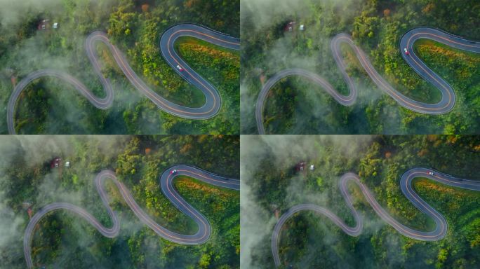 清晨森林中的乡村公路鸟瞰图。无人驾驶飞机飞过乡村公路，在山间有雾。泰国南省的标志性旅游景点