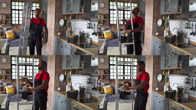 一个修理工在家庭厨房里安装梯子