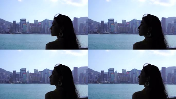 女人站在星光大道看香港岛风景维多利亚风光