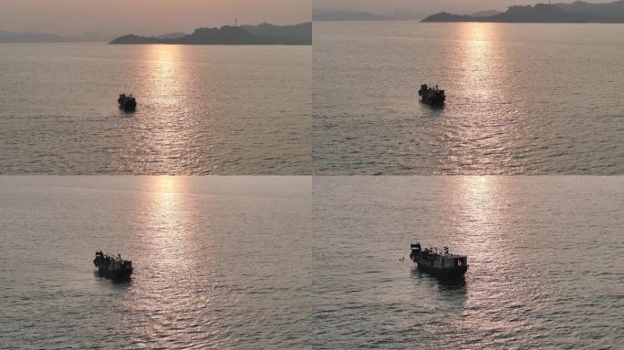 黄昏落日渔船在大海上捕鱼
