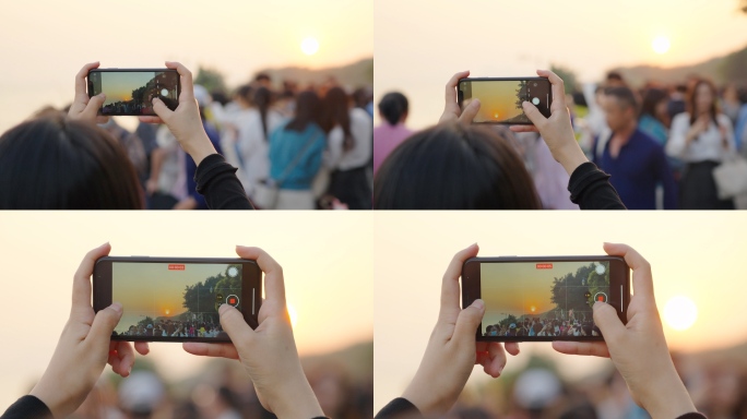 女孩用手机拍摄夕阳记录生活
