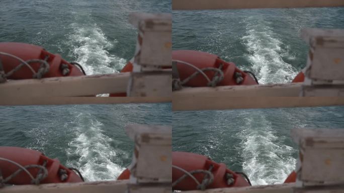 由舷外马达的运动螺旋桨推出的白色巨浪泡，