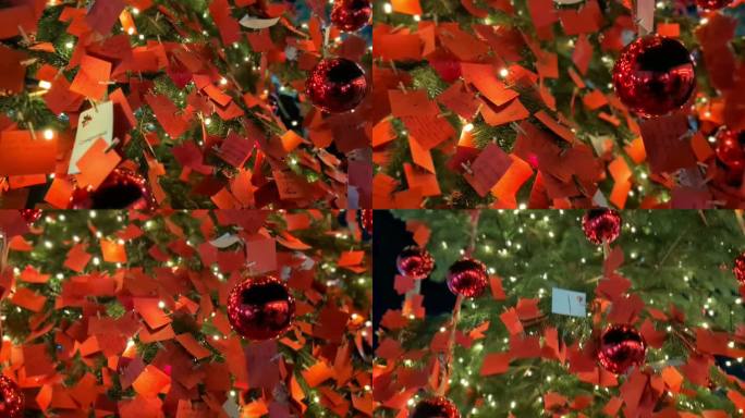 圣诞节和新年的外部装饰。绿色的树上装饰着红色的音符和球，闪烁的花环，明亮的灯。圣诞树。温馨的圣诞气氛