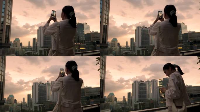 亚洲女性游览泰国曼谷市中心欣赏日落时的摩天大楼