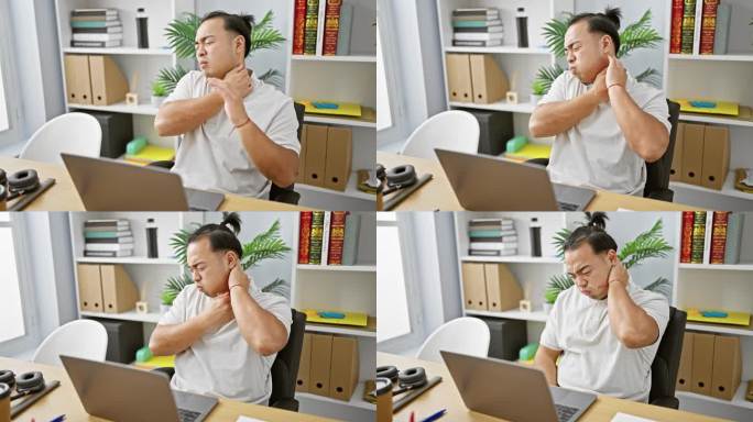 压力巨大的中国年轻商务工作者在办公室里盯着笔记本电脑，与颈椎疼痛作斗争