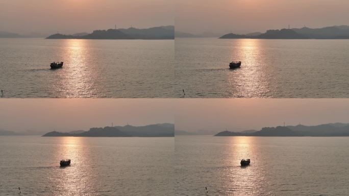 黄昏落日渔船在大海上捕鱼