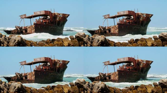 海浪冲击着阿古拉斯角海岸线上锈迹斑斑、饱经风霜的旧船残骸