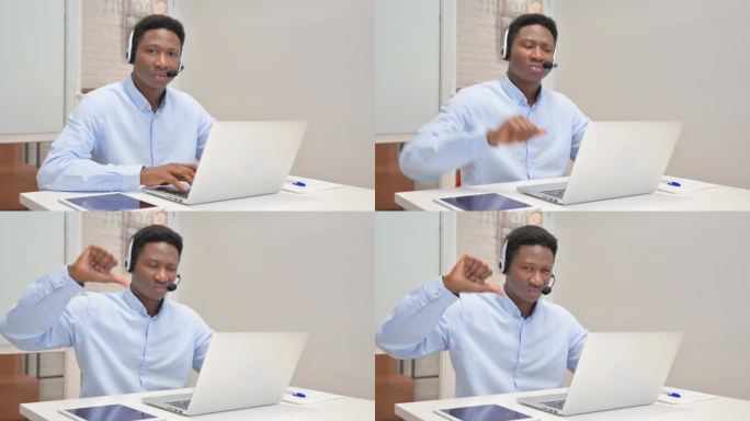 在呼叫中心戴着耳机使用笔记本电脑的非洲人表示反对