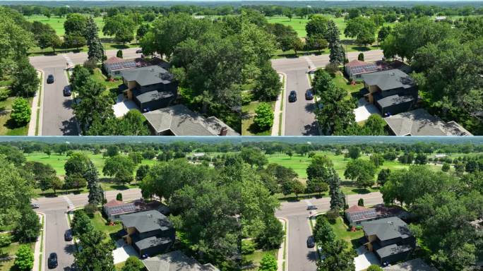 鸟瞰图，一个郊区社区有一个安装了太阳能电池板的房子，通往公园和高尔夫球场的人行横道，一辆汽车在路上行