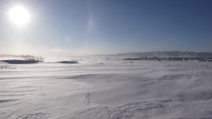 极寒天气下风吹动马路上的雪花