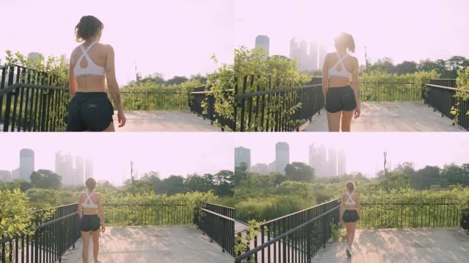 一名女子在跑步后冷静下来，站在市中心的桥上看着自然保护区