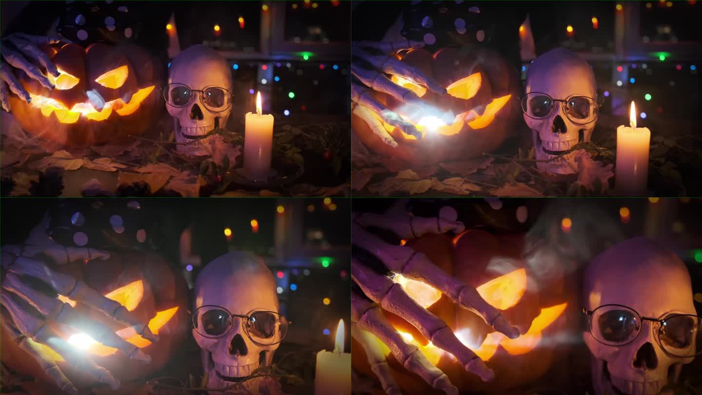 特写:恐怖的手放在南瓜灯上，在万圣节节日装饰的背景下闪烁着骷髅头，摇曳的蜡烛，