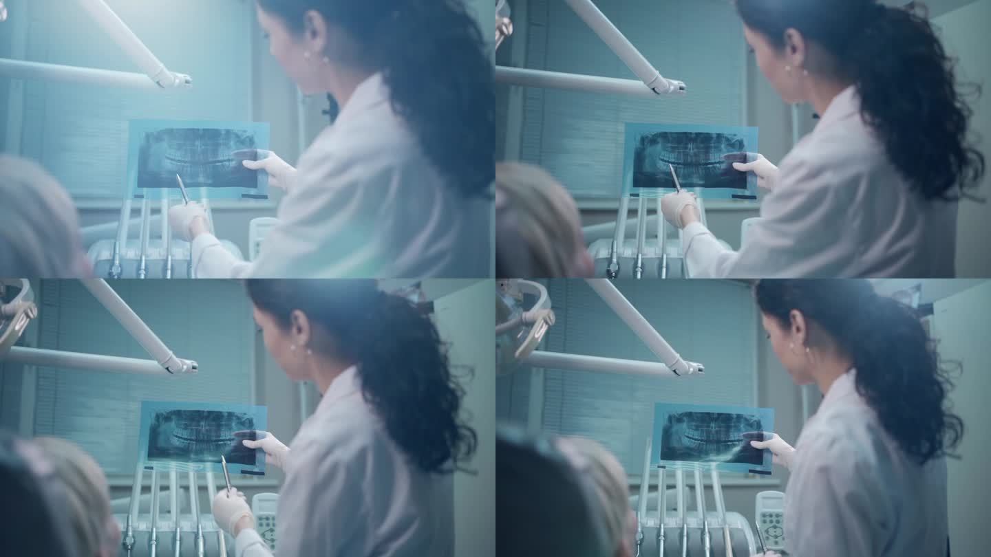 专业女牙医向患者展示口腔全景x线图像