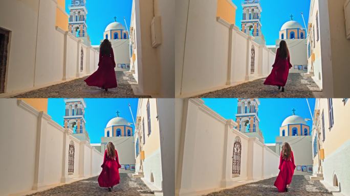 在圣托里尼，一个穿着红裙子的漂亮女孩正走向有大钟的大教堂。