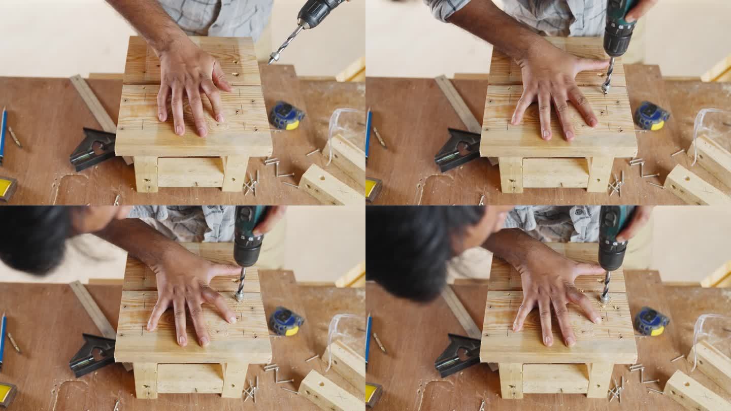 木匠用电钻钻洞。用金属钻头在橡木板上打洞做小椅子