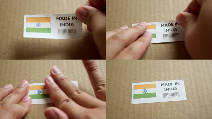 手应用在印度制造的旗帜标签上的运输箱与产品优质条码。制造和交付。产品出厂进出口。