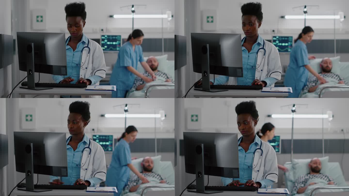 非裔美国医生在电脑上输入医学专业知识的正面视图