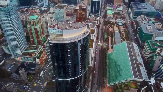 高角度无人机平移拍摄温哥华市。崭新的玻璃摩天大楼，汽车从下面驶过