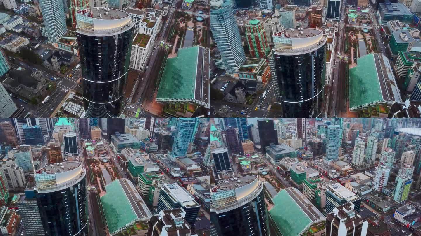 高角度无人机平移拍摄温哥华市。崭新的玻璃摩天大楼，汽车从下面驶过