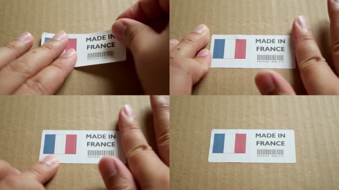 手应用制造在法国国旗标签上的运输箱与产品优质条码。制造和交付。产品出厂进出口。