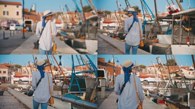 在克罗地亚村庄的港口码头上，女游客边走边拍照