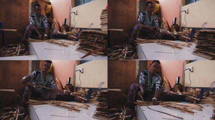 女性制作工艺品的SLO镜头。雌性正在使用干棕榈叶。她在工作。