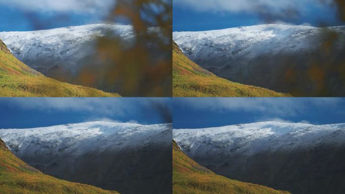 秋天，挪威苔原上的高山和丘陵上新下的雪。视差视频。