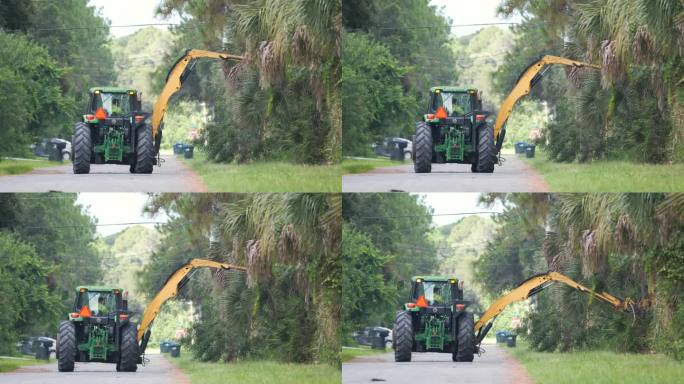 公共工程拖拉机在佛罗里达州乡村街道边修剪树木和绿化树枝