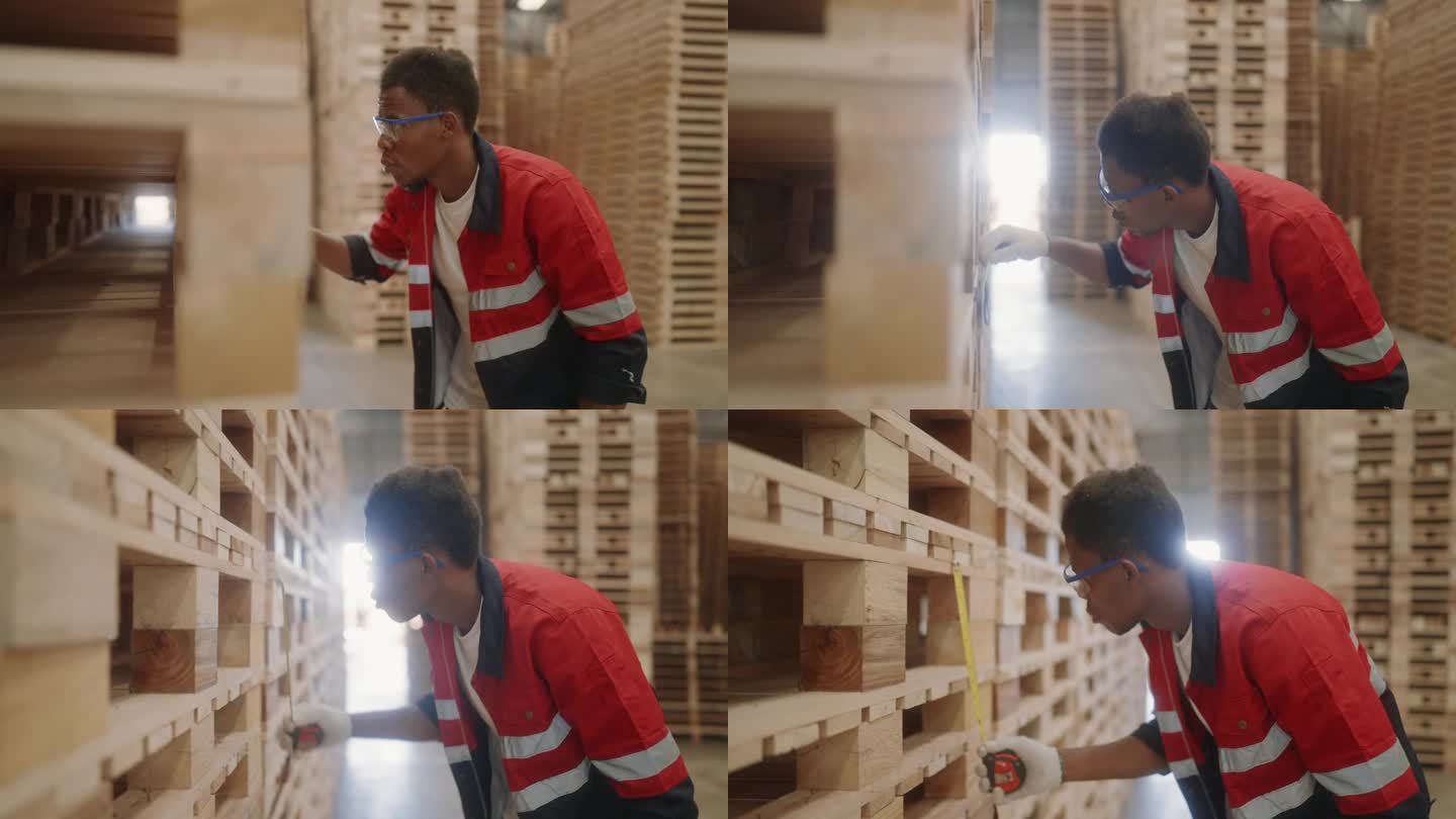 熟练的非洲工人在木棚检查木材库存。