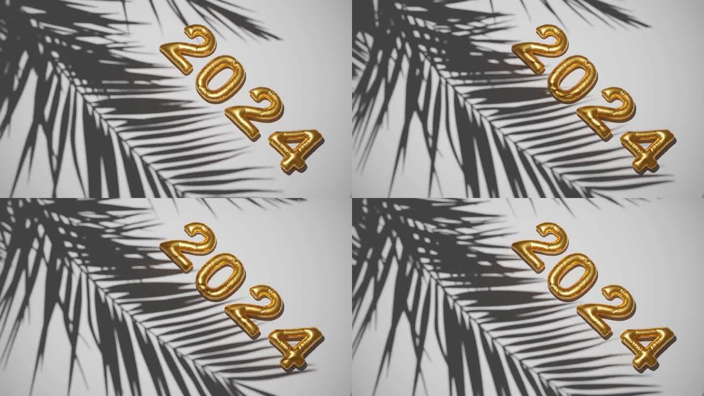 2024年金球在剪影棕榈白色背景上