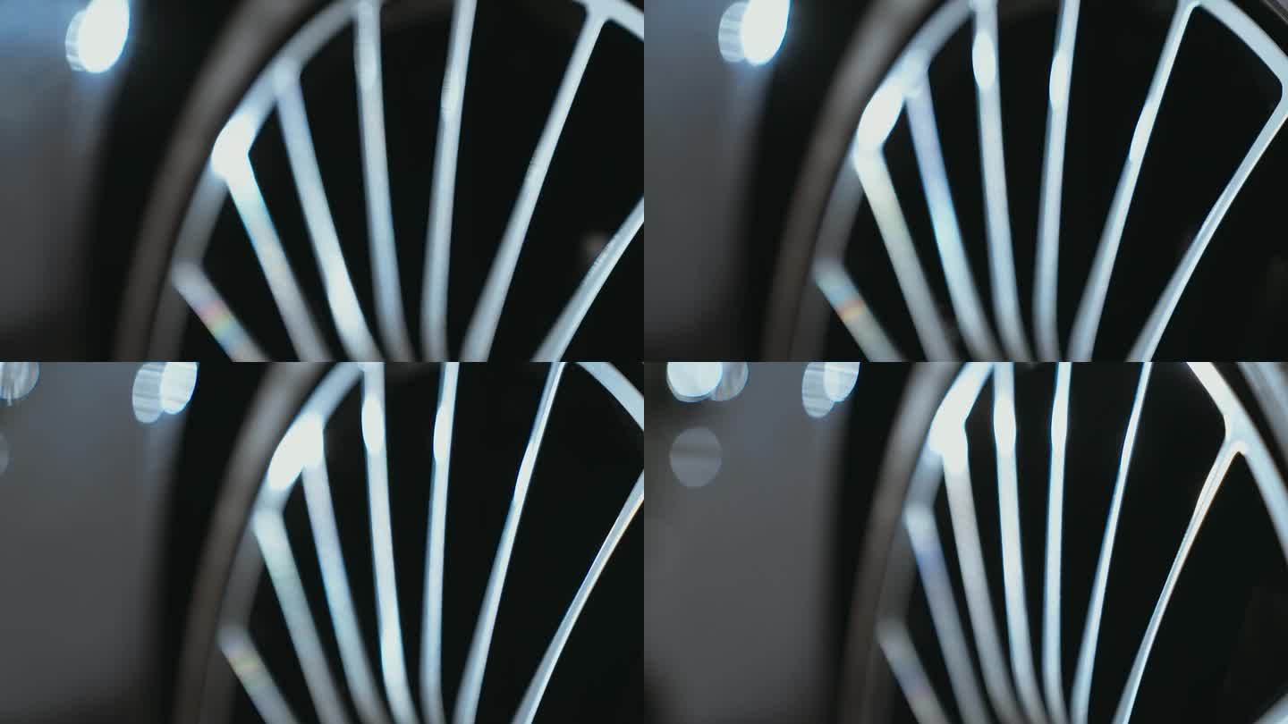 极近距离的镜头盘闪亮的反光黑色金属表面的一个全新的汽车与金属轮辋