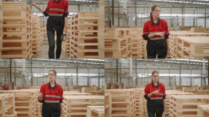 高加索女性木工专业人员在木材厂检查库存。