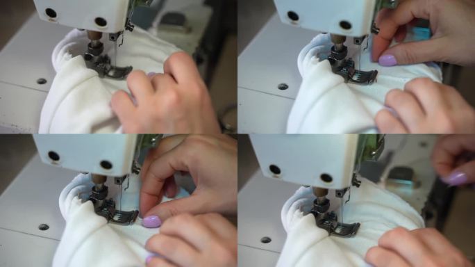 用缝纫针和线缝合白色织物的过程，创造完美的接缝，裁缝在缝纫机的复古工作室工作，修理衣服和制作时装设计