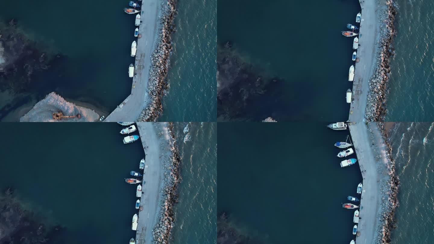 希腊海滩鸟瞰图，宁静的水域和散落的船只