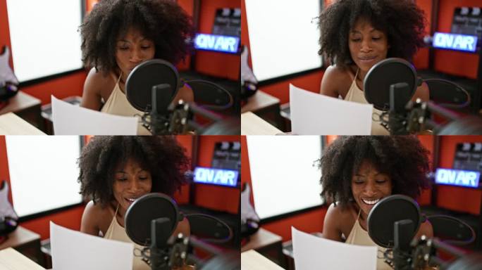 在广播工作室工作的非裔美国女广播记者阅读剧本