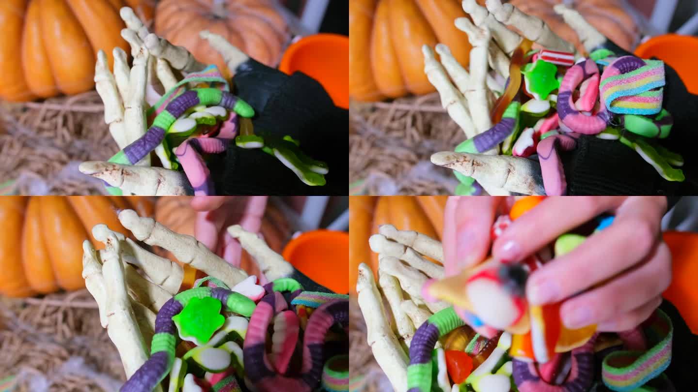 不给糖就捣蛋，万圣节的传统游戏，特写，穿着骷髅服装的手收集成堆的糖果，并把它们倒进橙色的桶里