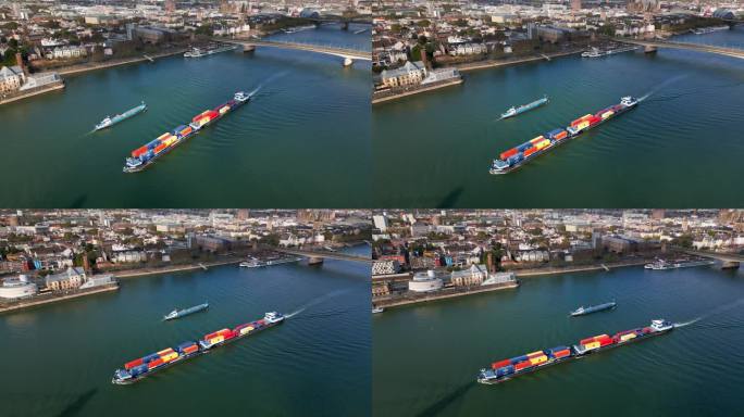 在德国科隆，一艘货轮载着集装箱在莱茵河上与科隆大教堂一起快速行驶