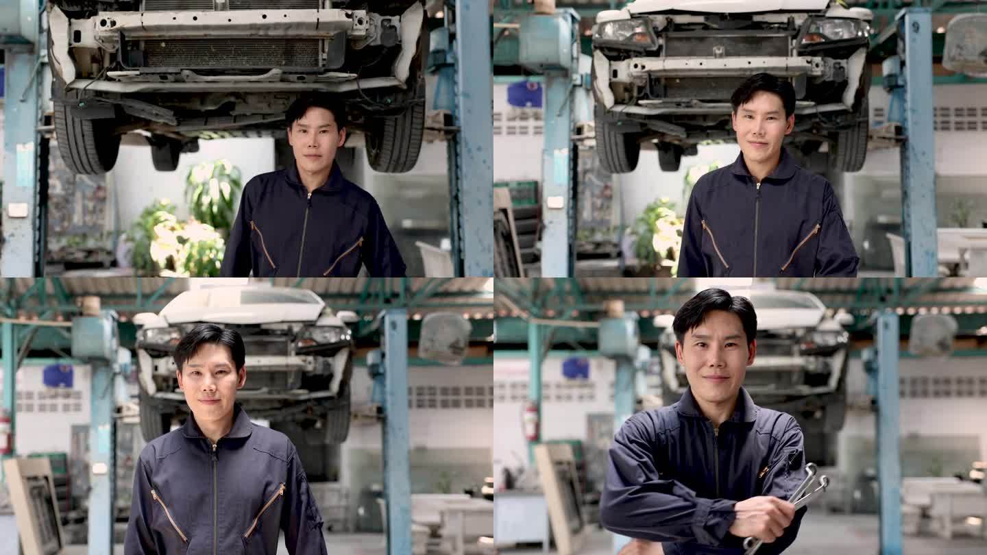 小企业主的生活方式理念，亚洲企业家汽车维修店站在汽车吊车前笑容满面，机械师穿着制服，手里拿着扳手表演