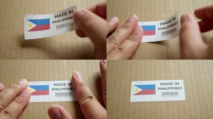 用手将菲律宾制造的旗帜标签贴在带有产品优质条形码的运输箱上。制造和交付。产品出厂进出口。