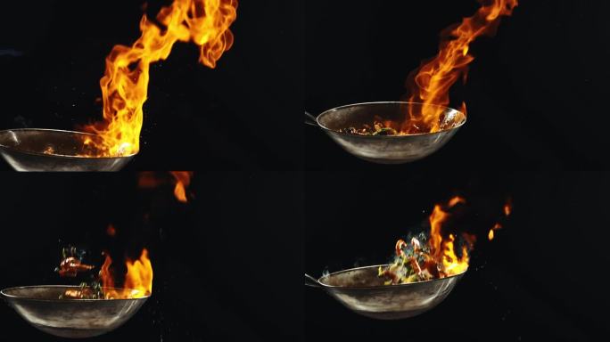 厨师烹饪美味的炒面，炒菜和虾在黑色背景的火焰锅