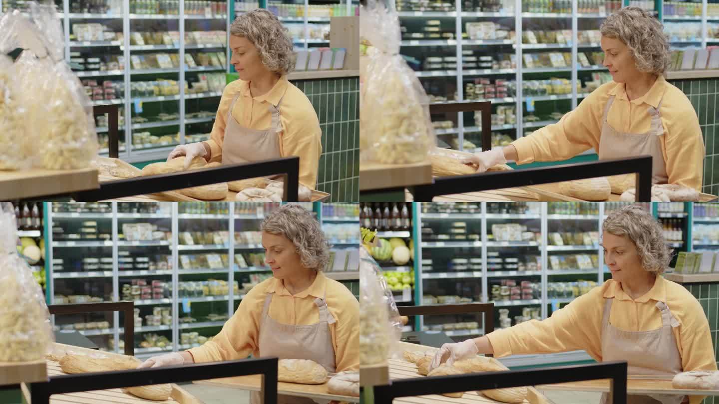 超市工作人员在货架上摆放新鲜面包