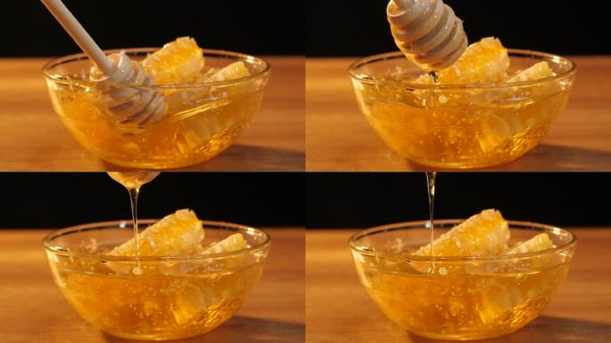 健康食品。木制蜂蜜勺。液体新鲜蜂蜜。蜂蜜滴着，从蜜罐里倒出来。