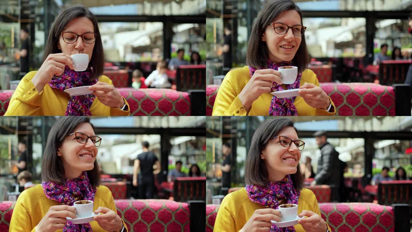 伊斯坦布尔，一名年轻女子在路边咖啡馆喝咖啡
