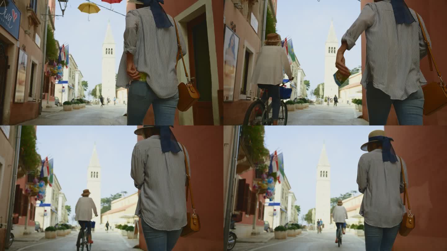 克罗地亚罗维尼，一名女游客在走向教堂塔楼时从口袋里掏出地图