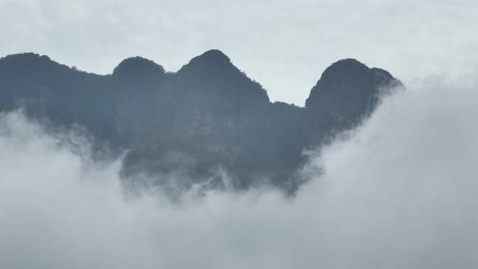 航拍云雾缭绕下的山峰云层之中来宾圣堂山