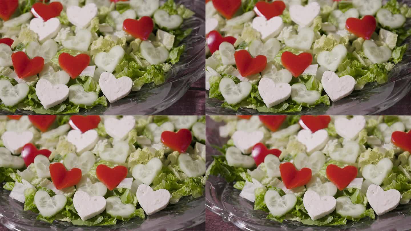 新鲜的沙拉，盘子里有红、绿、白的心形图案。